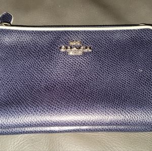 Navy blue Coach wristlet.